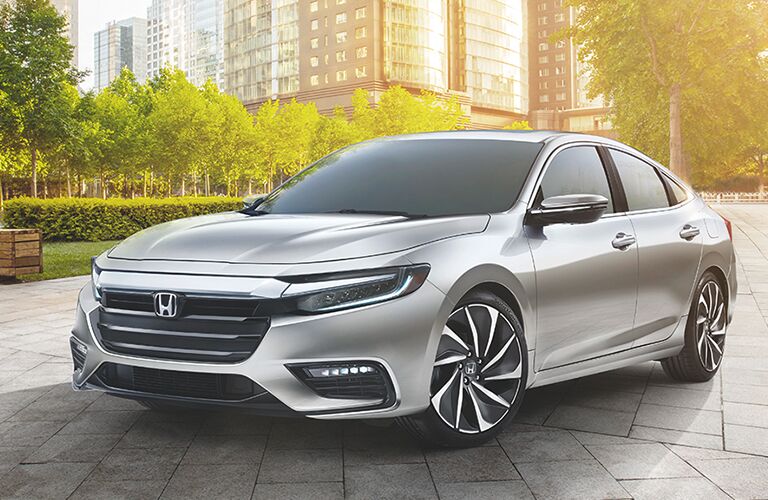 silver Honda Insight parked in a park