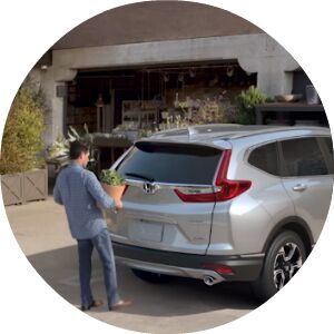 man putting foot under Honda CR-V to use hands free tailgate feature