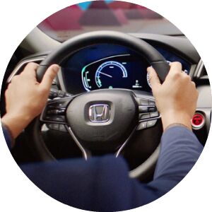 close-up view of hands on a Honda steering wheel