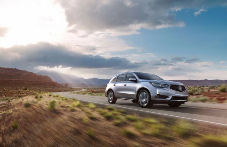 2017 Acura MDX driving down the highway