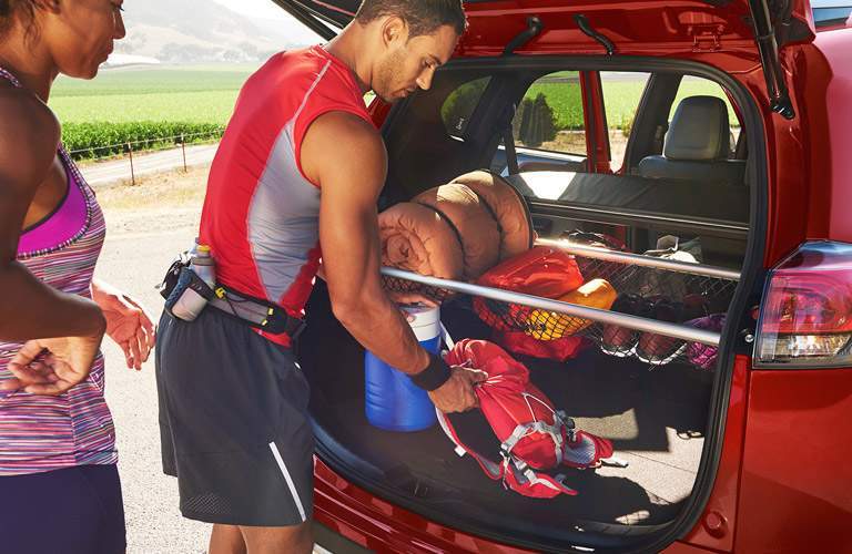 Man and woman getting items out of trunk of 2017 Toyota RAV4