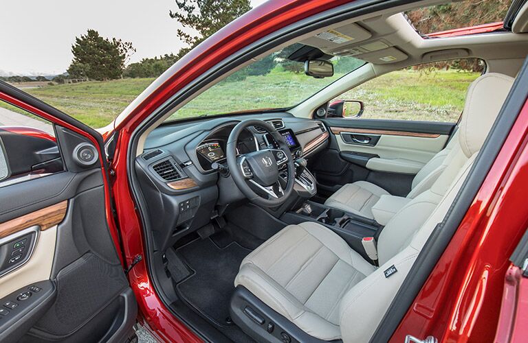 Open door of the 2019 Honda CR-V revealing the front seats and dashboard