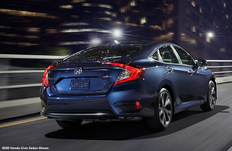 View of the 2020 Honda Civic Touring sedan driving on the highway at night