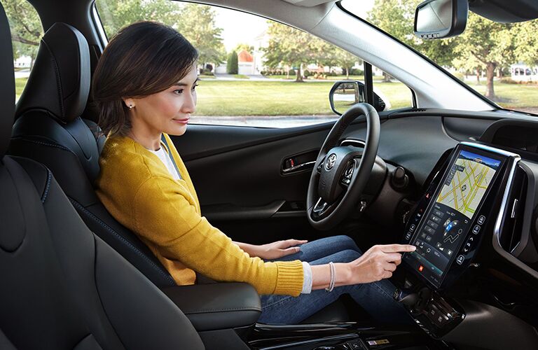 A woman in the driver's seat of the 2020 Toyota Prius