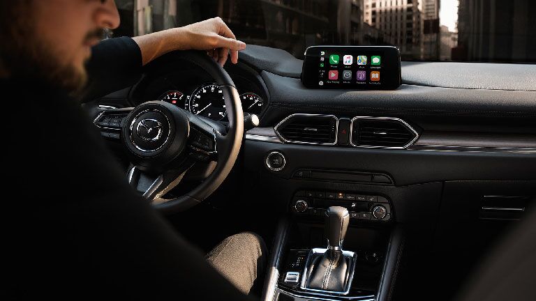 Interior view of someone driving the 2019 Mazda CX-5