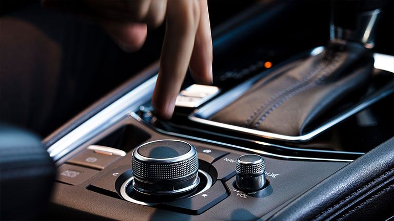 Someone adjusting the transmission settings inside a 2019 Mazda CX-5