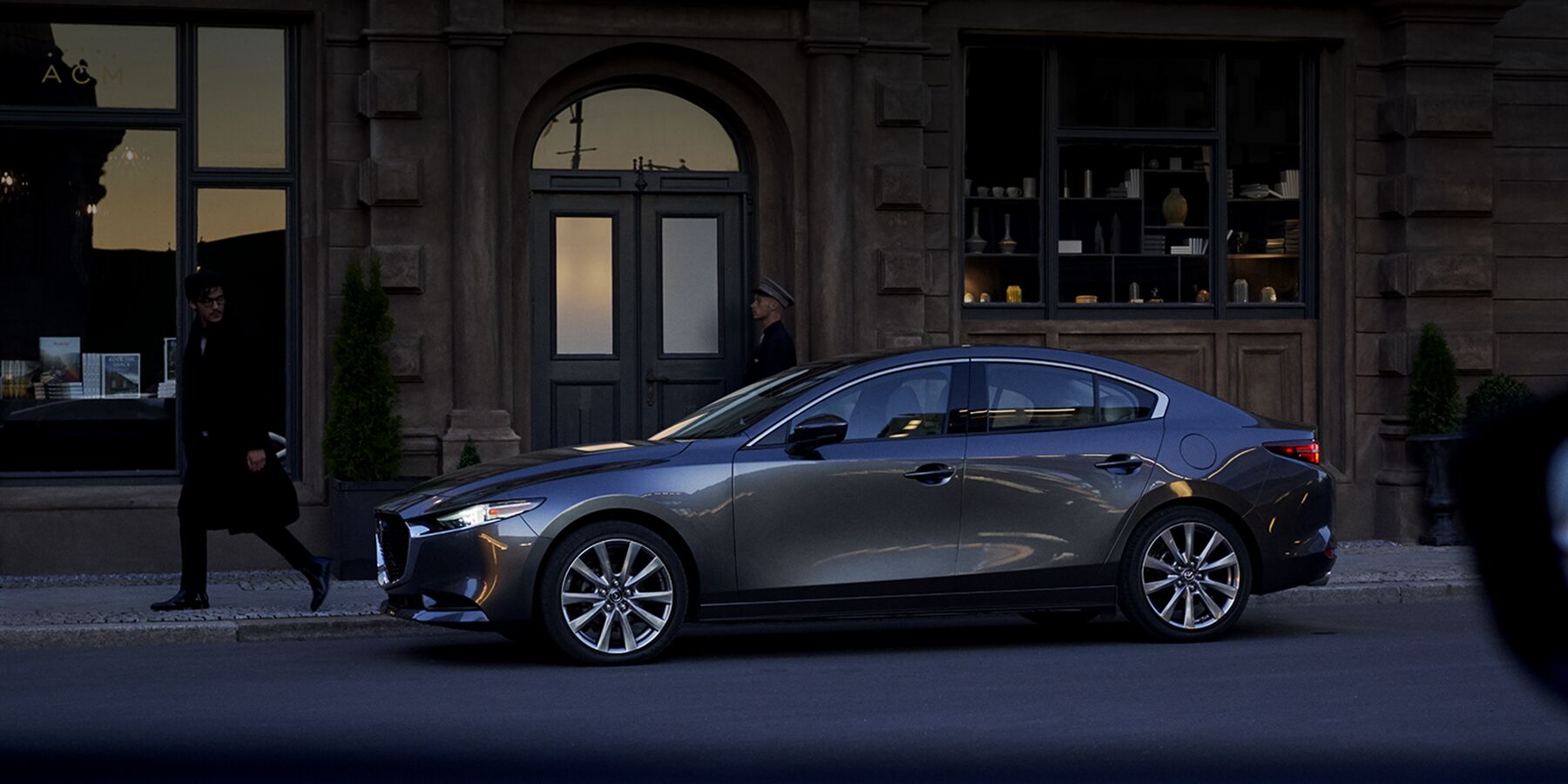 A 2019 Mazda3 sedan outside a house