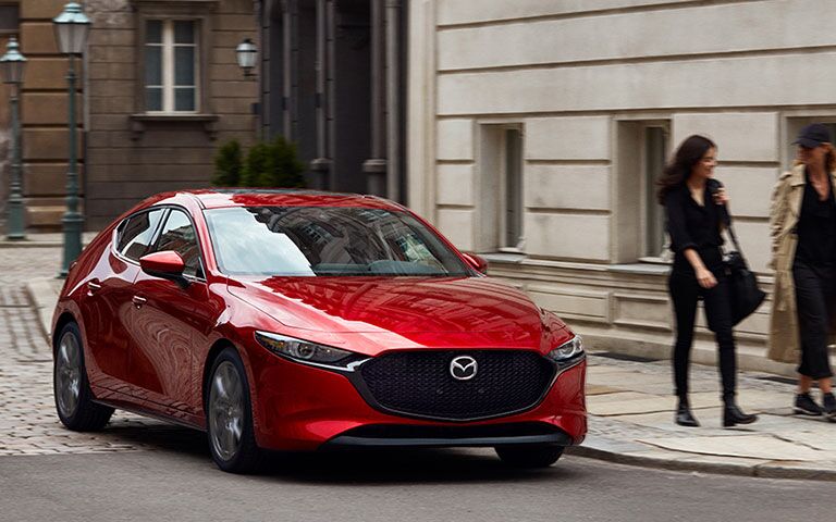 2019 Mazda3 on the street next to pedestrians