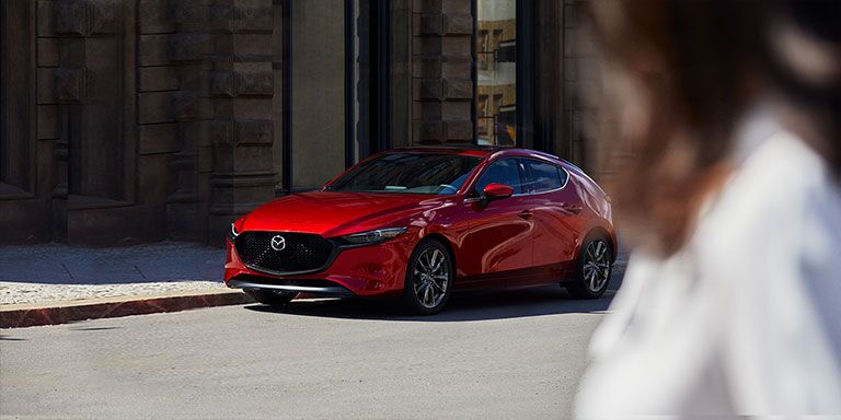 A 2019 Mazda3 hatchback on a city street