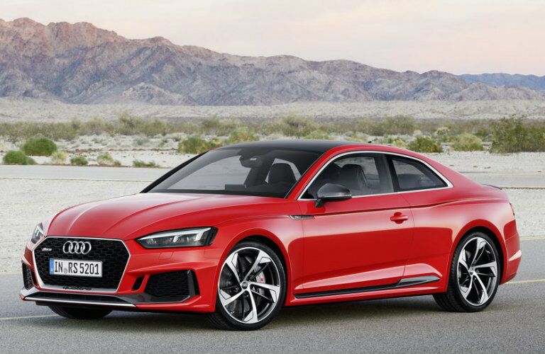 red Audi RS 5 parked in desert