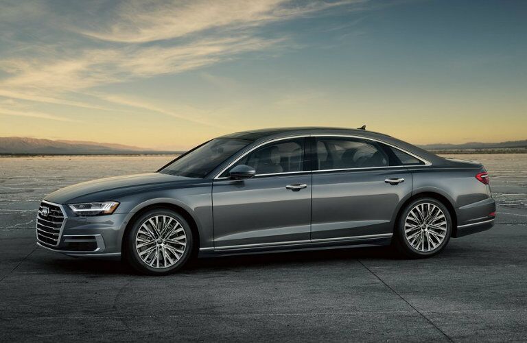 side profile of gray Audi A8 parked on wide open area