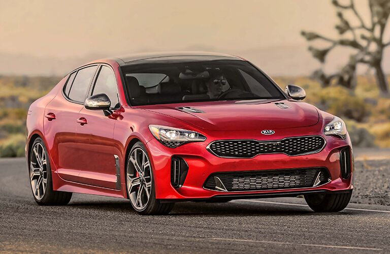 red Kia Stinger driving