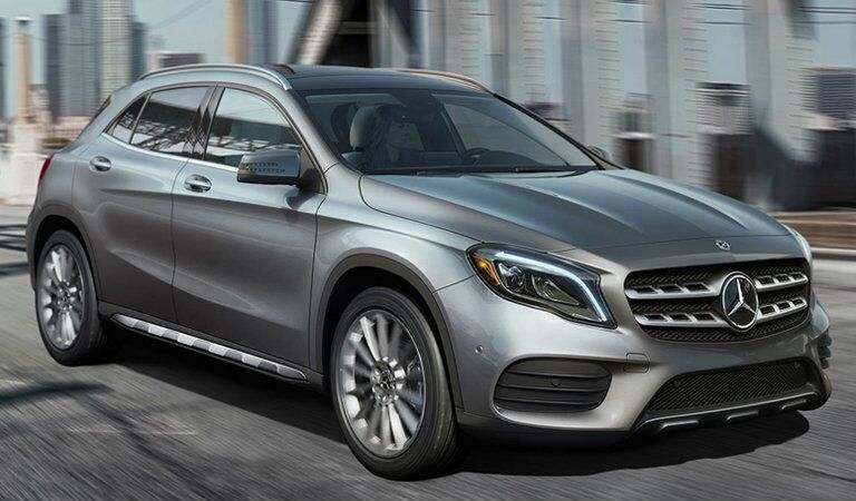 silver 2018 Mercedes-Benz GLA driving over a city bridge