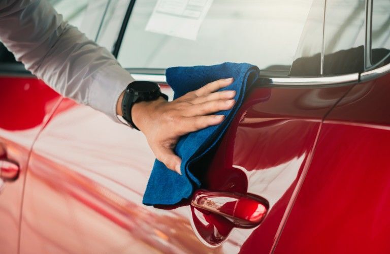 Cleaning a Red Car with a Blue Rag