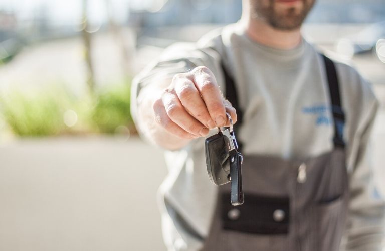 Man Holding Car Keys