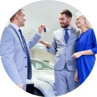 Salesman Handing Keys to a Happy Couple