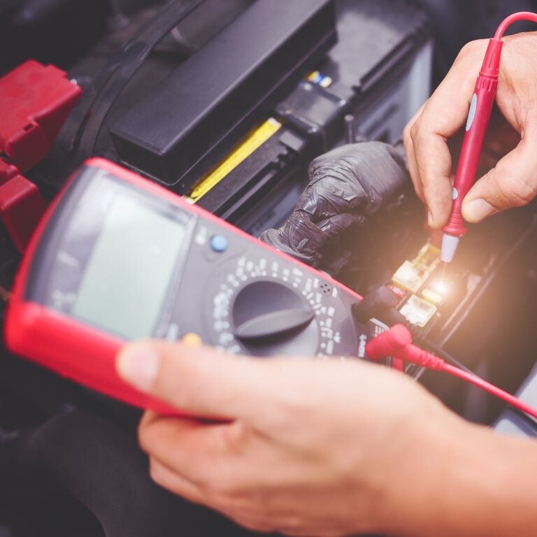 Tech checking a car battery