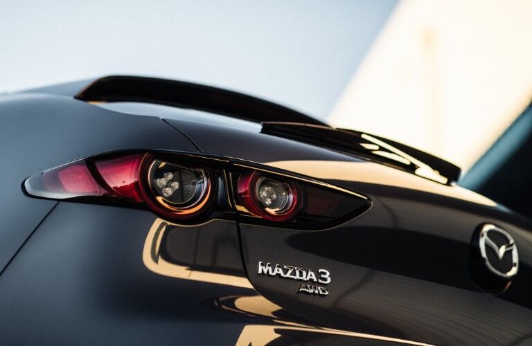 2020 Mazda3 Hatchback exterior rear closeup shot of trunk, bumper, taillights, and model and AWD badge