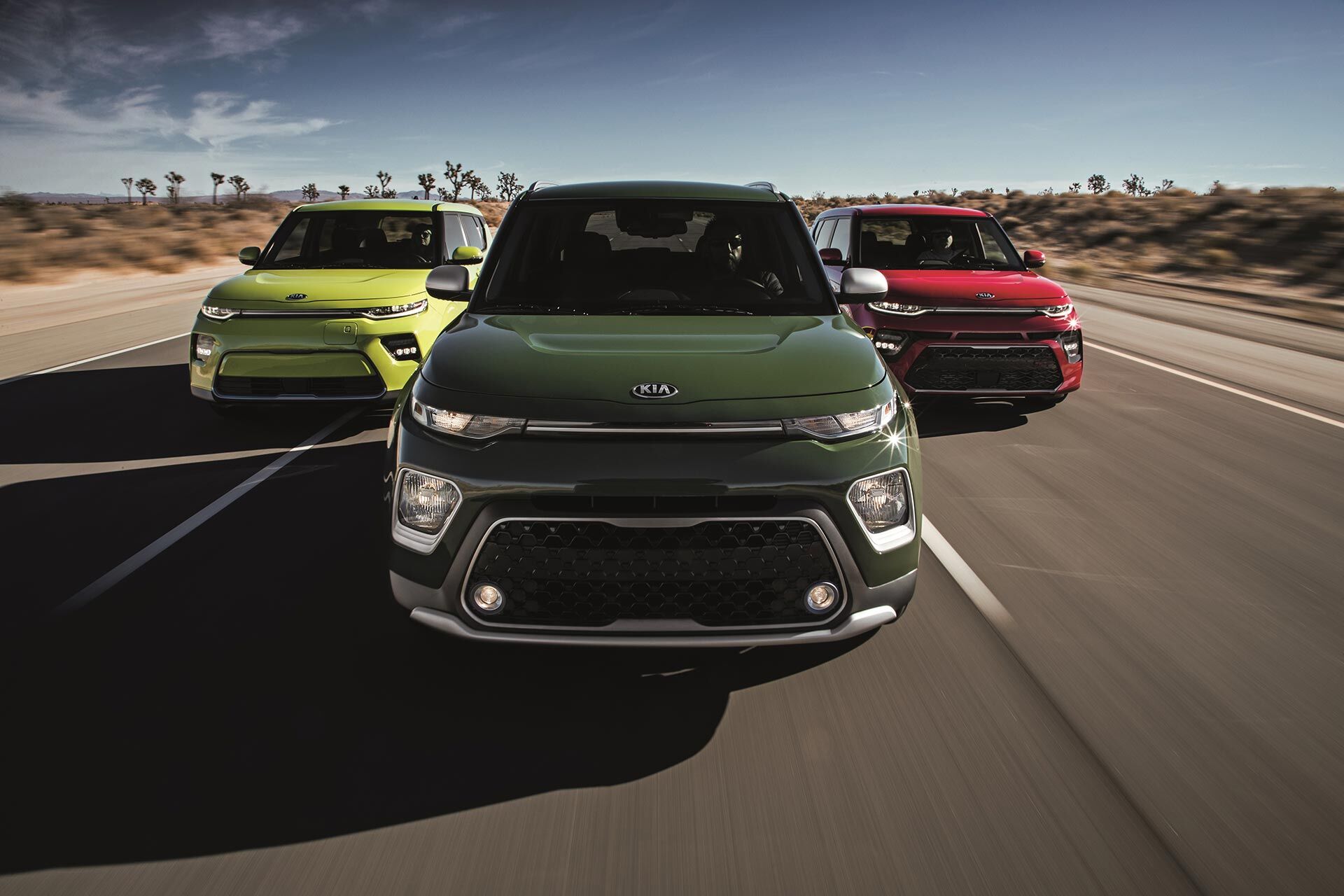 Three 2020 Kia Soul driving down the highway