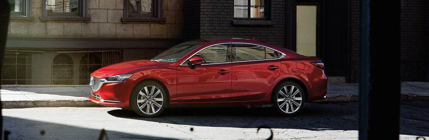 Exterior view of a red 2019 Mazda6 parked on a city street