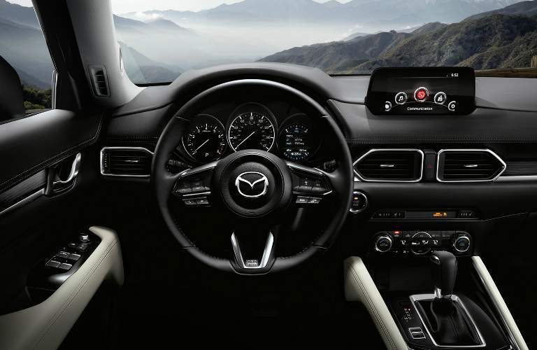 front interior of 2018 mazda cx-5 including steering wheel, dashboard and infotainment system
