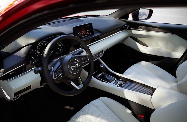 front interior of 2018 mazda6 including steering wheel, seats and center infotainment interface
