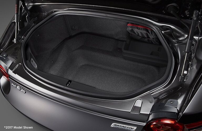 rear cargo space of 2018 mazda miata with trunk open