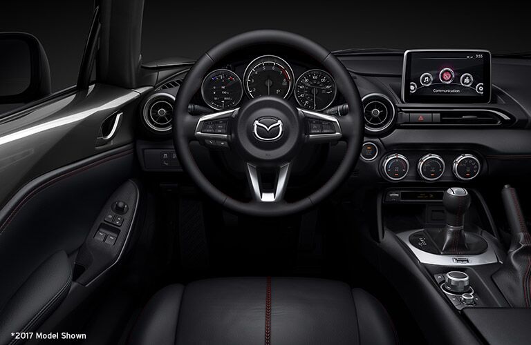 front interior of 2018 mazda miata including steering wheel, dashboard and infotainment system