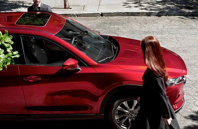 2019 Mazda CX-5 red parked on the road with people