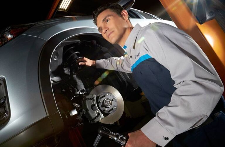 Mazda service technician working on a car
