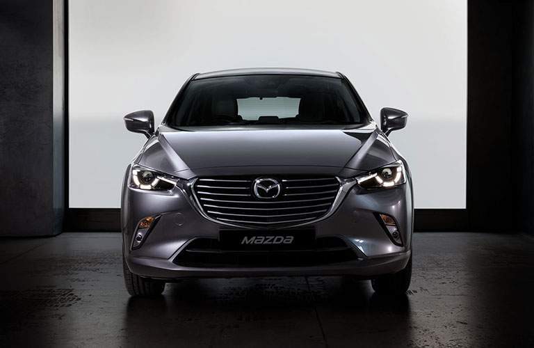front view of silver 2018 mazda cx-3 against white and black background