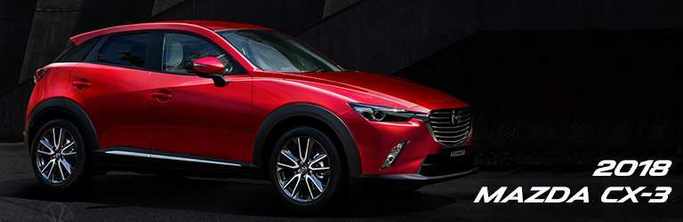 red 2018 Mazda CX-3 in a dark alley