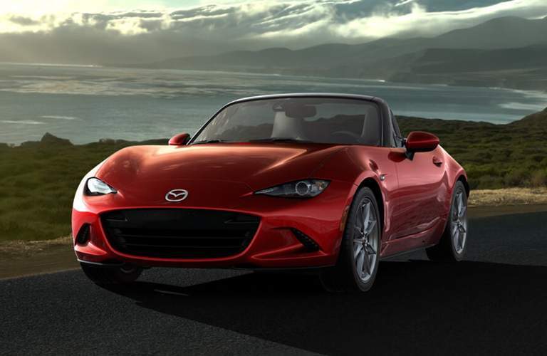 red mazda miata at sunset