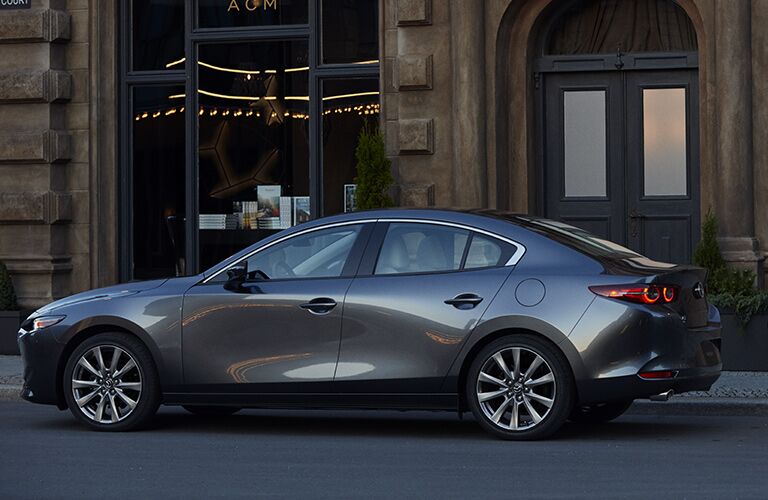 left side view of gray mazda3 parked