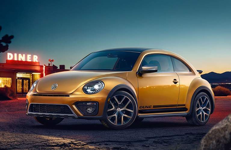 gold volkswagen beetle parked outside diner