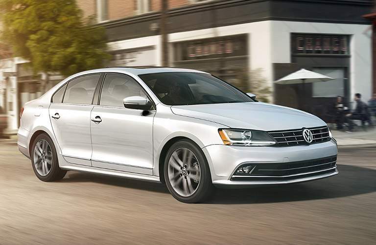 white volkswagen jetta driving in city