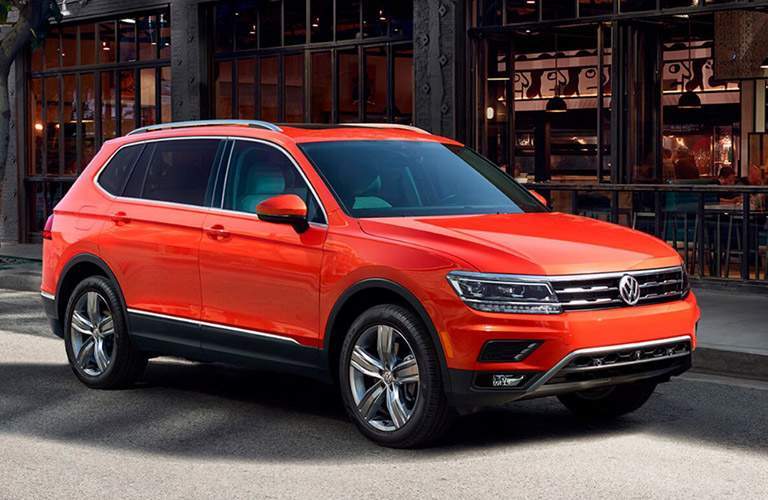 orange volkswagen tiguan parked on street