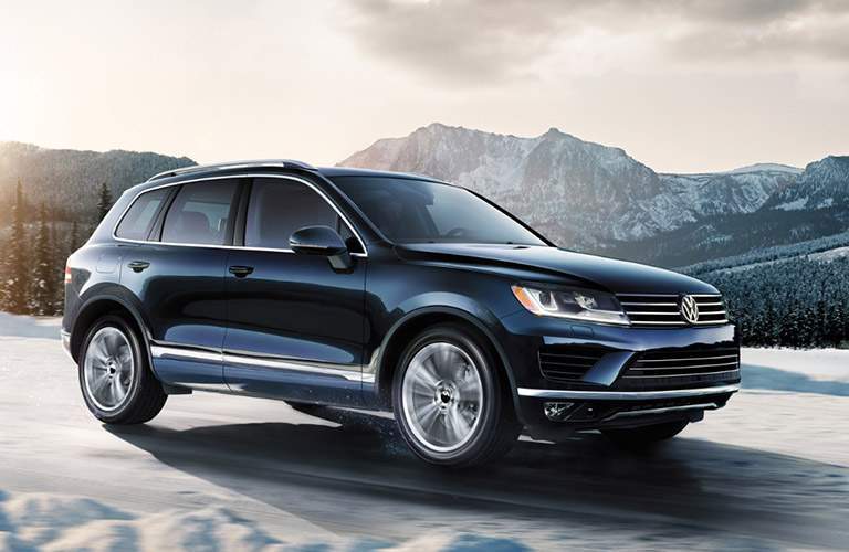 black volkswagen touareh driving on snow
