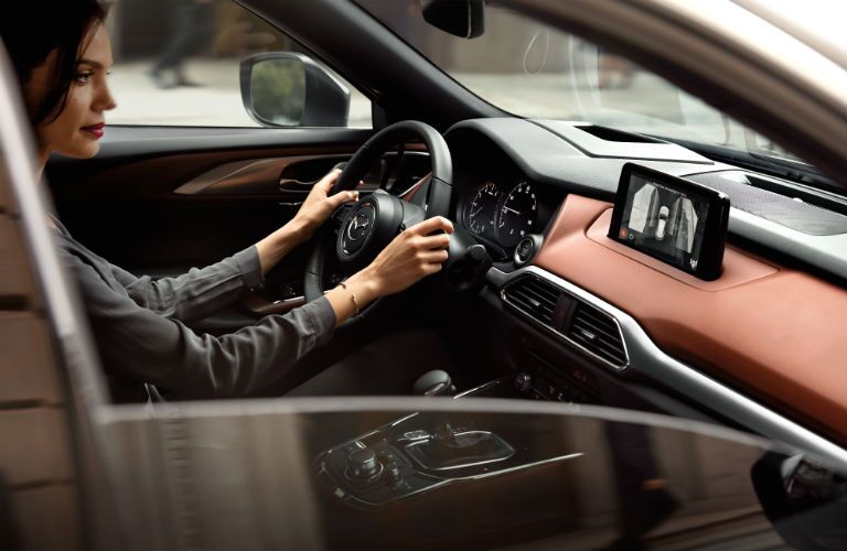 A photo of someone using the rear view camera in the 2019 Mazda CX-9.