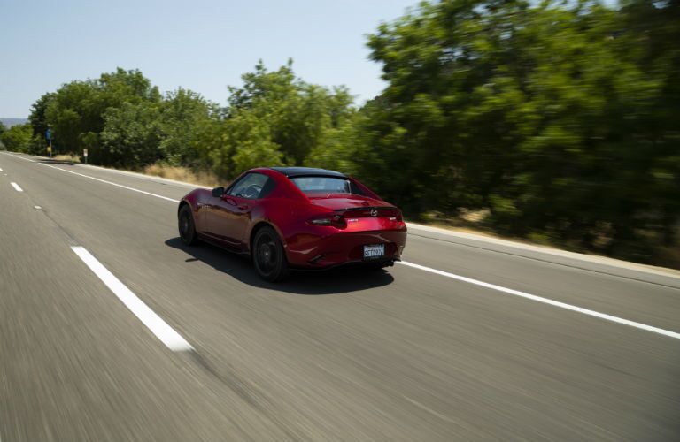 A rear left quarter photo of the 2019 Mazda MX-5 Miata RF on the road.