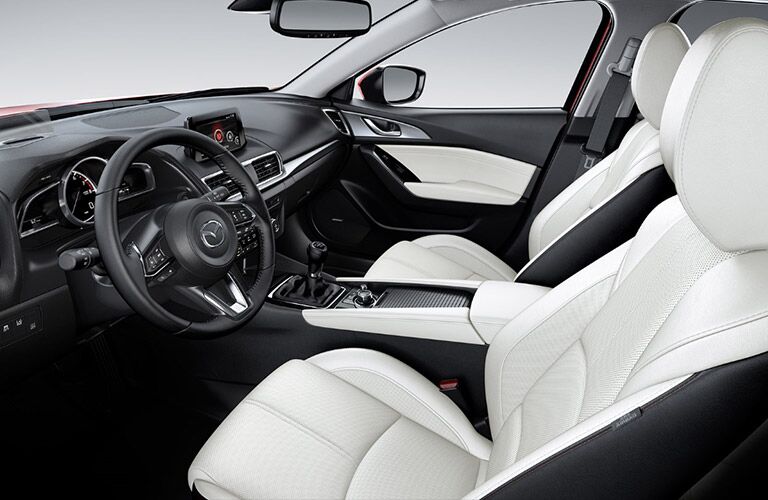 An interior photo of the front seats in the 2018 Mazda3.