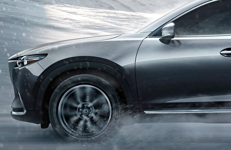 front end of gray mazda cx-9 driving in snow