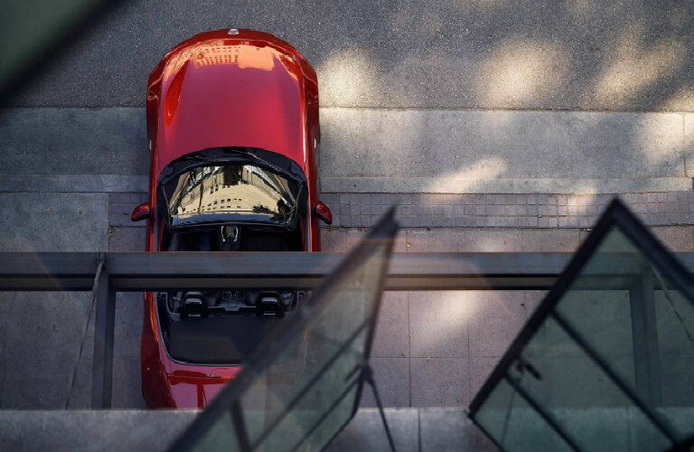 2018 Mazda MX-5 Miata exterior overhead shot red from a window sill down to the street