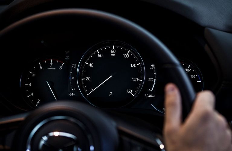 Closeup of steering wheel and gauges in 2019 Mazda CX-5