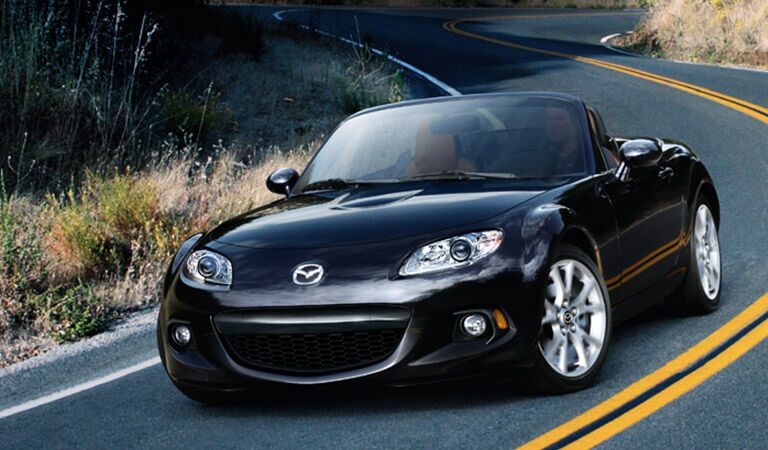 Mazda MX-5 Miata Driving Down Road in Black