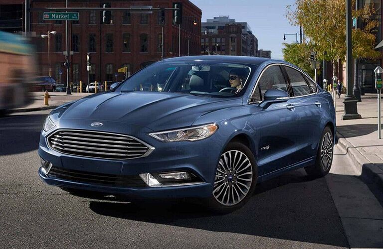 2018 Ford Fusion pulling away from a curb