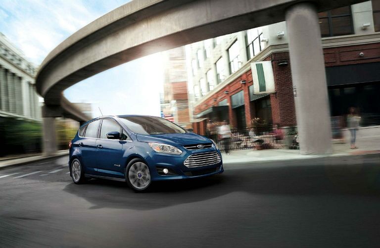 2018 Ford C-MAX Hybrid turning a corner by a cafe