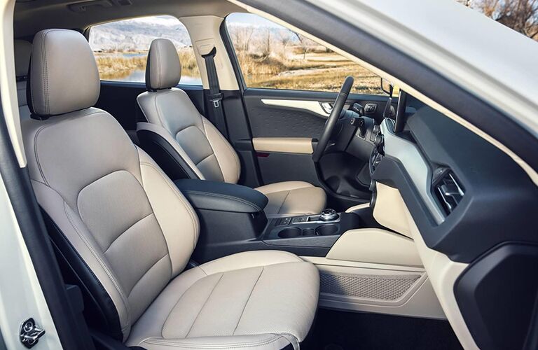 2020 Ford Escape interior side shot of front seating upholstery, steering wheel, and dashboard design and layout