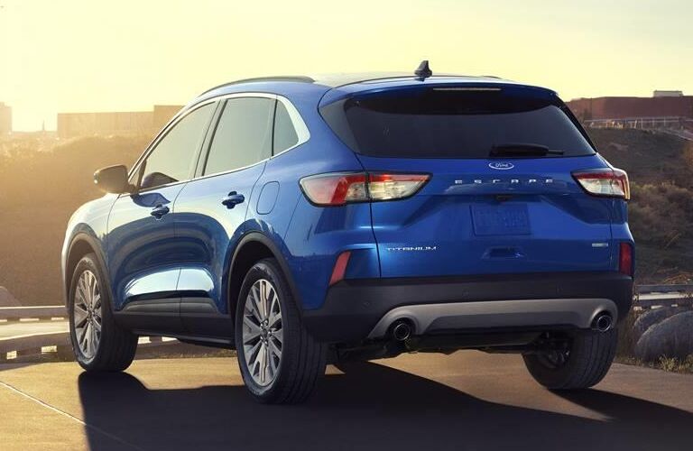 2020 Ford Escape Titanium rear shot with blue paint color under a bright sunset