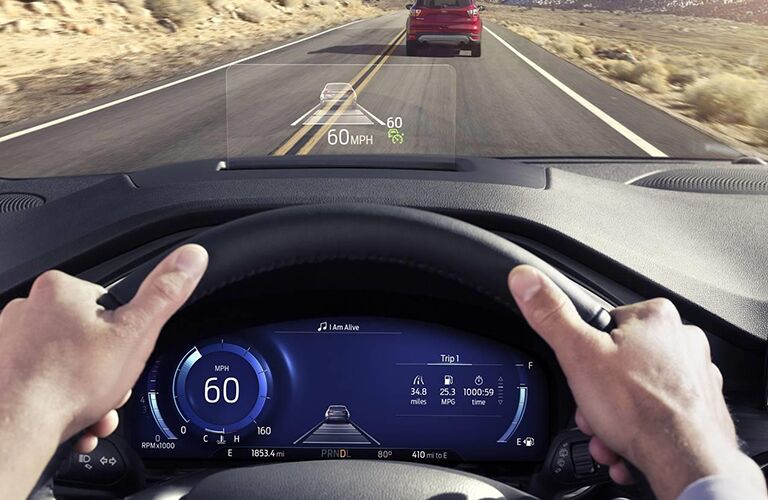 2020 Ford Escape interior driver's view shot driving on a desert highway with driver's cluster display and head up display